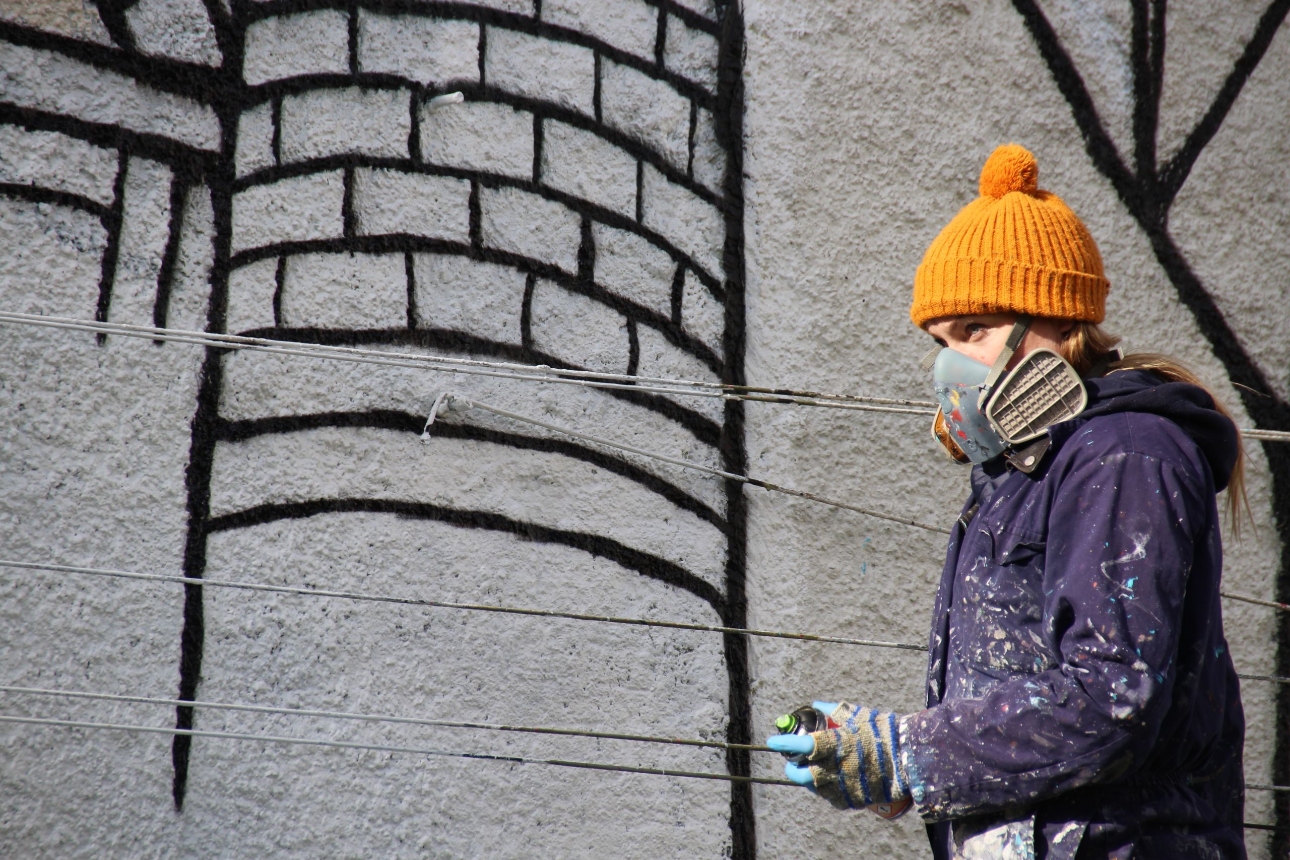 Jo Peel working on her mural in Howard Street
