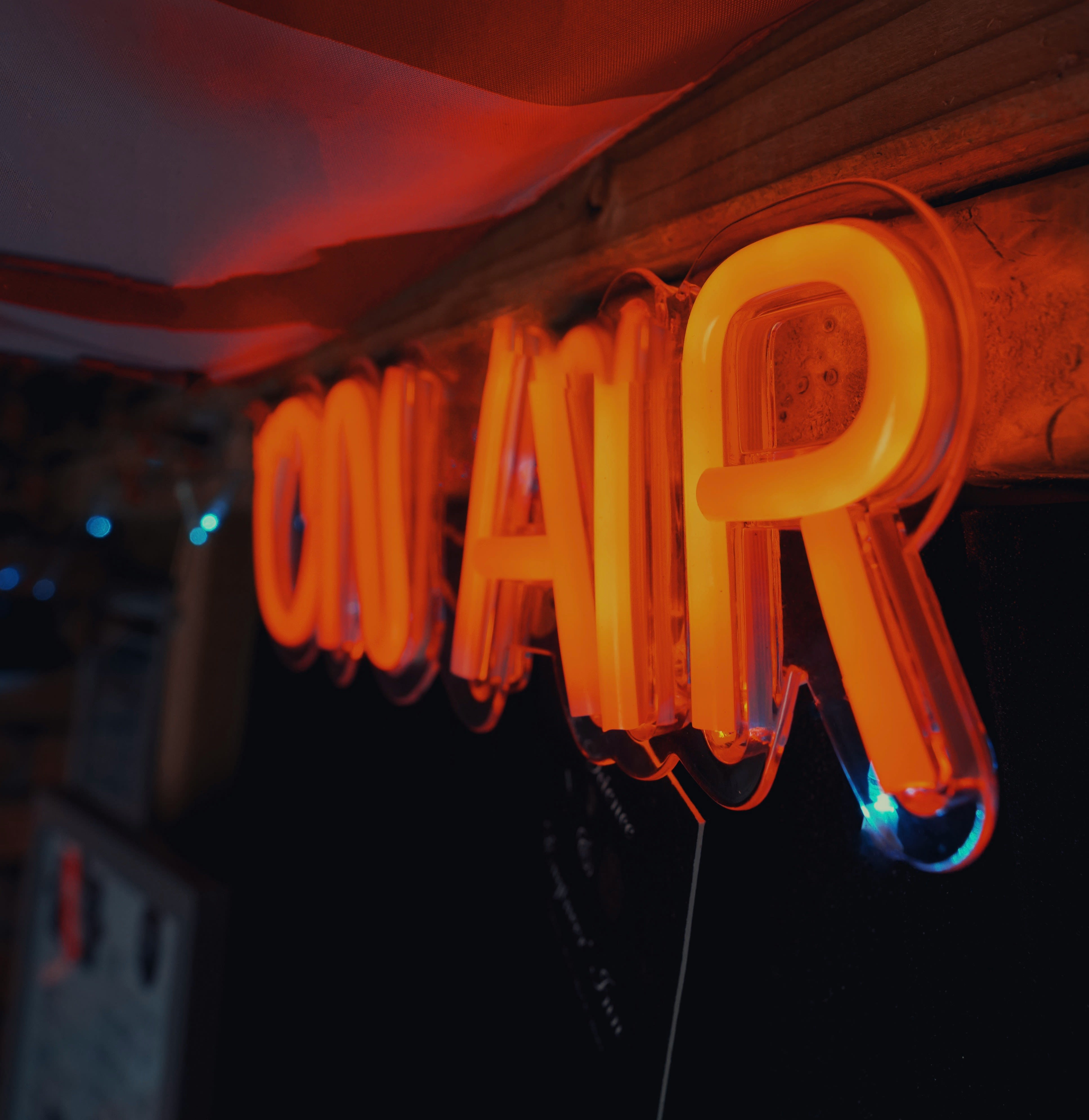 a neon sign hanging from the side of a wall