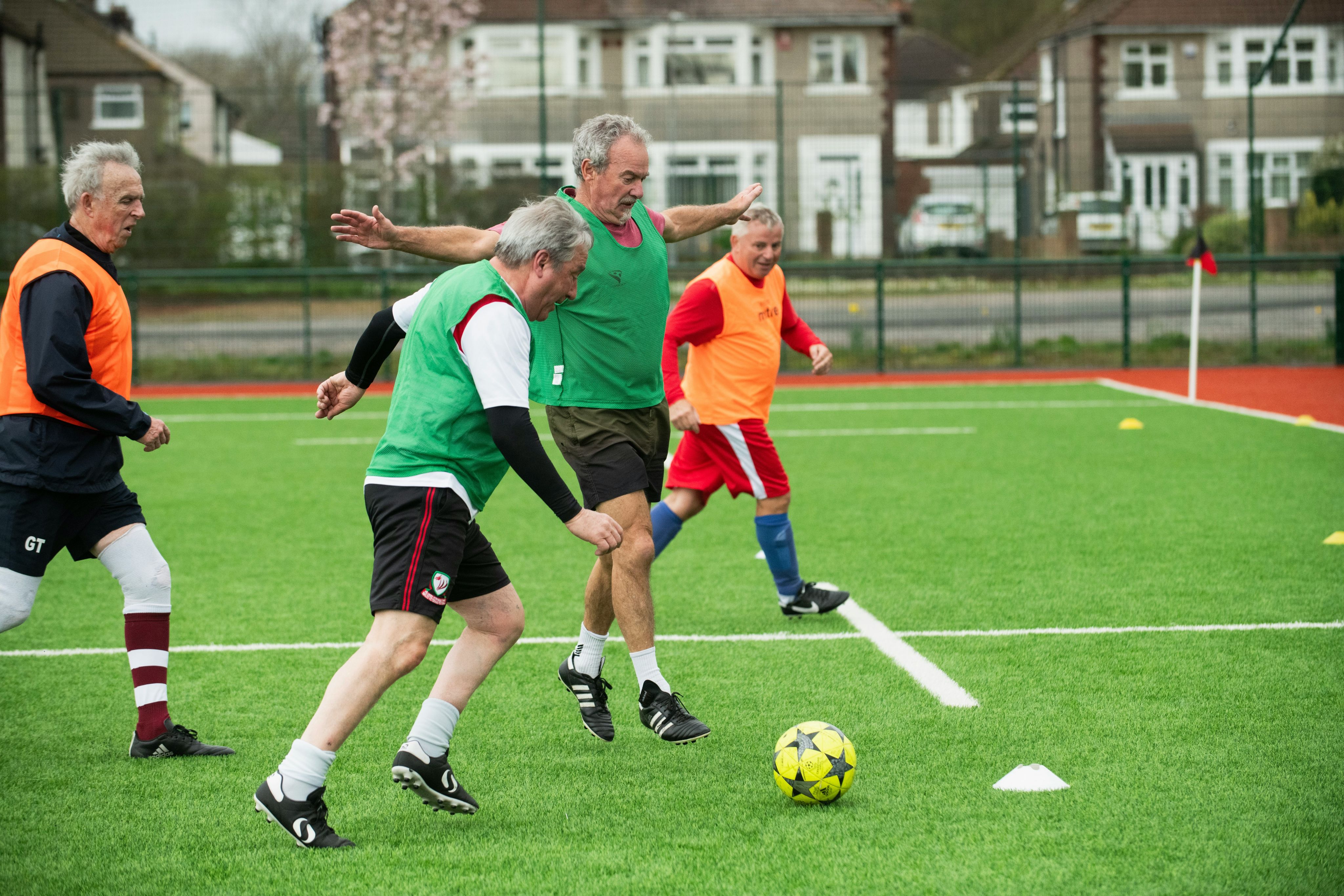 A group of people playing soccer on a field
